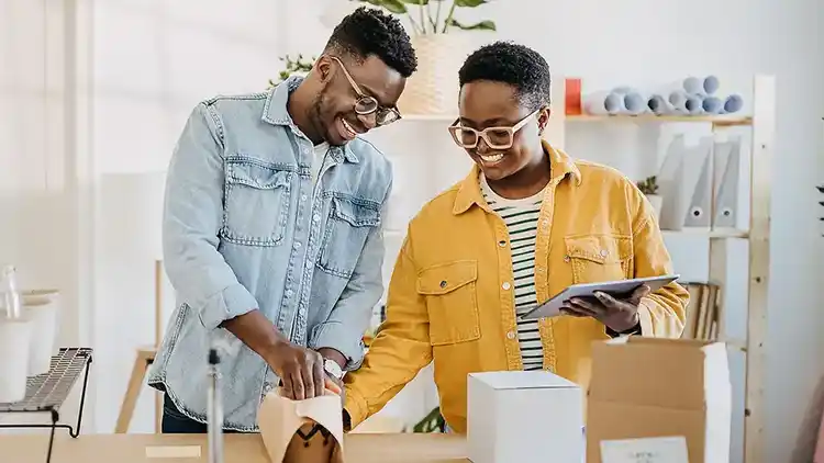 Business couple getting ready to return a shipment to their customer.