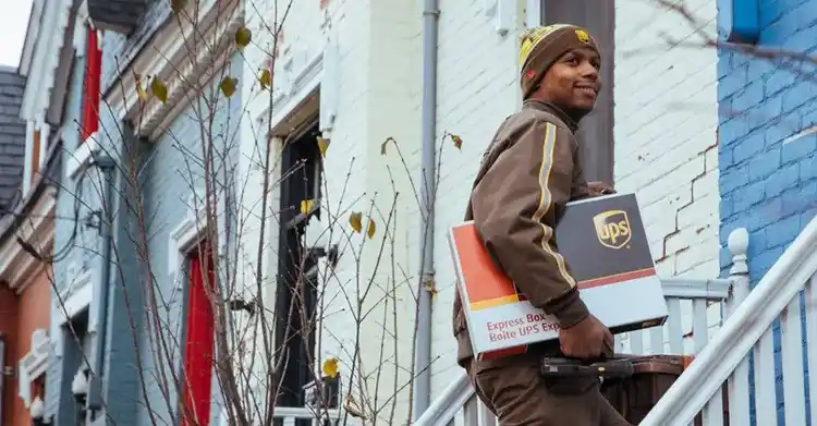 UPS driver delivering a package to a residence