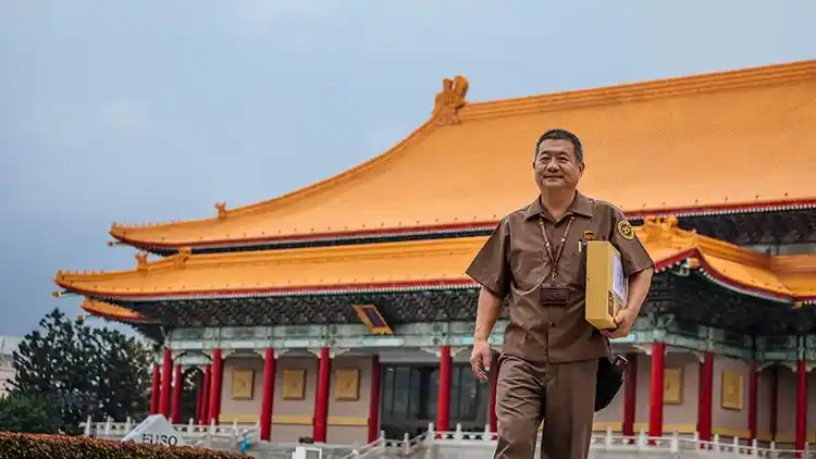 UPS worker holding package