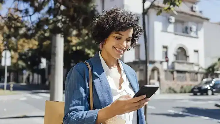 Person walking outside tracking on the U-P-S mobile app.