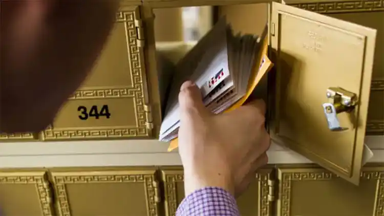 A customer receiving mail from their The UPS Store mailbox.