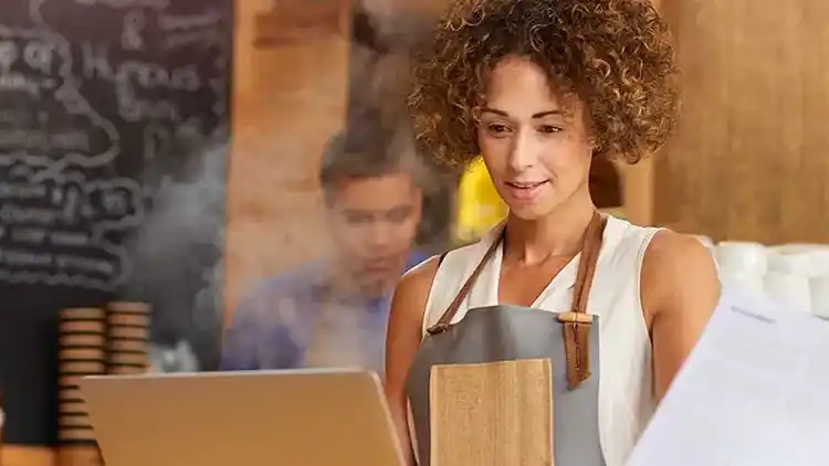 A small businessperson using their computer at work.